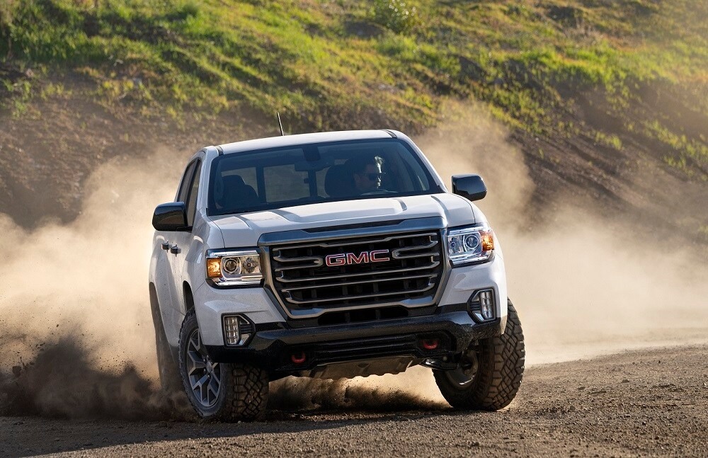 GMC Truck driving through gravel and sand