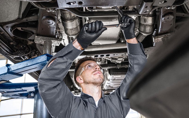 GMC Service Technician working on a car